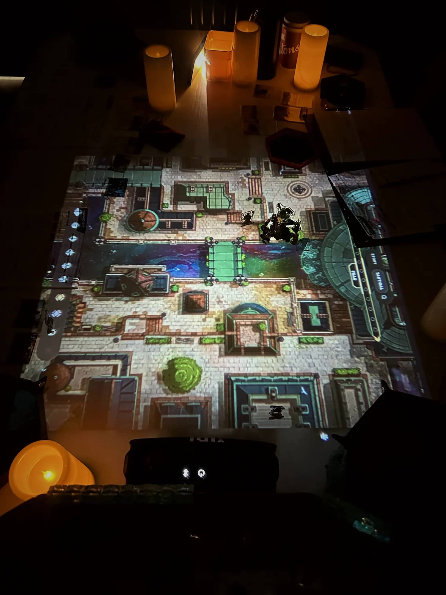 A dungeon map lit by real candles at the edge of the table