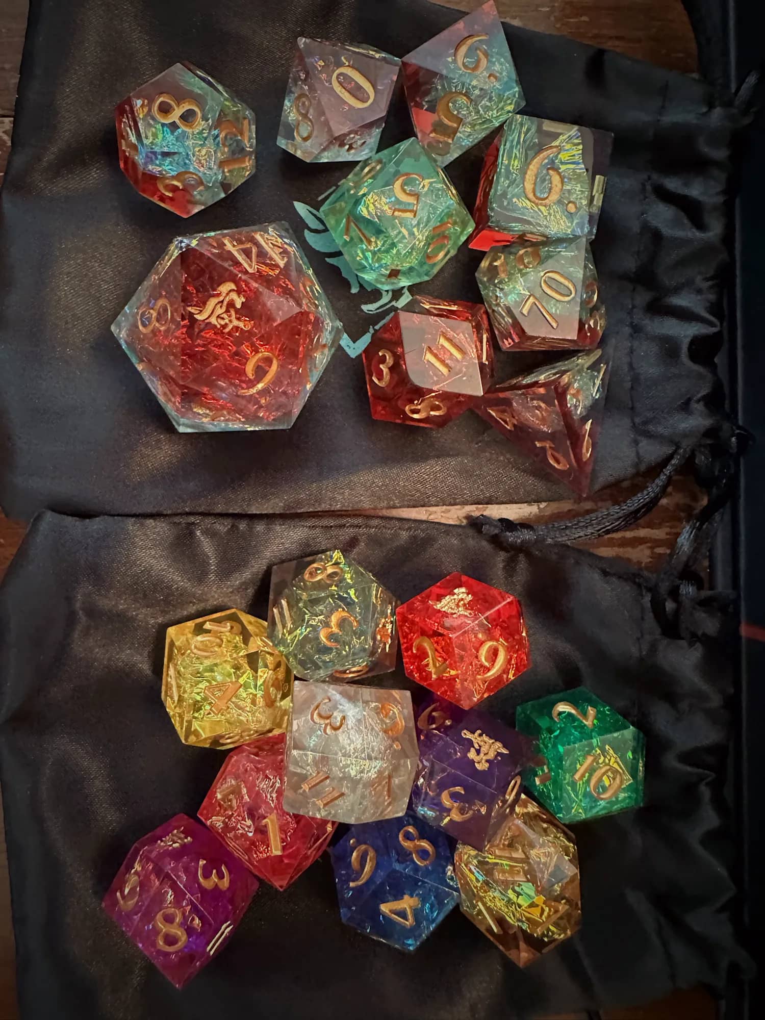 A set of hand-poured dice spilled across a dice bag